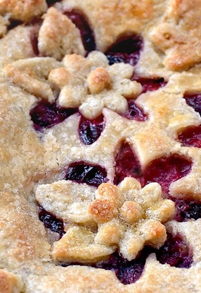 This Magnificent Mixed Berry Pie is the star of summer! Its buttery almond crust highlights summer's abundance of berries. Tender, flaky, and fruity!