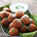 tray of fried mozzarella balls and small dish of yogurt dipping sauce