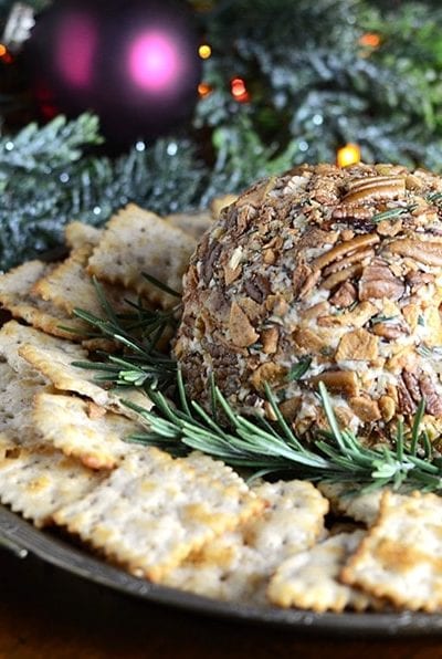 This sharp and creamy Easy Cheddar Cheese Ball will be a party favorite this holiday season! Aged cheddar is combined with cream cheese and rolled in butter roasted apple chips and pecans with a sprinkle of fresh rosemary. Just 7 ingredients for this no fuss, delicious recipe.