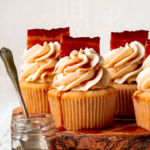 maple bacon cupcakes on a raw edge wooden board